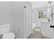 Clean, bright bathroom features a toilet, bathtub and shower, and a sink at 3679 Mill Glen Dr, Douglasville, GA 30135