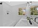 Bathroom featuring double sinks, tiled backsplash, and a shower-bathtub at 3679 Mill Glen Dr, Douglasville, GA 30135