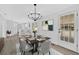 Dining room with modern chandelier, place settings, bar seating with kitchen view, and french doors at 3679 Mill Glen Dr, Douglasville, GA 30135