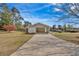Long driveway leading to a carport with ample parking and a well-manicured front lawn at 3679 Mill Glen Dr, Douglasville, GA 30135