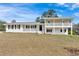 Charming two-story home with a white brick exterior and a lovely front porch at 3679 Mill Glen Dr, Douglasville, GA 30135