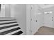 Hallway with stairs and an entry door with windows for natural light at 3679 Mill Glen Dr, Douglasville, GA 30135