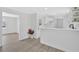 Open concept kitchen and living space with white walls, white cabinets, and light-colored floors at 3679 Mill Glen Dr, Douglasville, GA 30135
