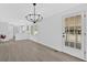 Living space with new light fixture, new floors, and view of backyard from the french doors at 3679 Mill Glen Dr, Douglasville, GA 30135