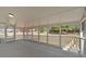 Screened-in porch with white railing, concrete floor, and view of the backyard at 3679 Mill Glen Dr, Douglasville, GA 30135