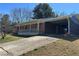 A single-story brick home featuring a convenient, attached carport for covered parking at 726 Shoreline Se Trl, Conyers, GA 30094