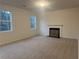 Bright and open living room with large windows and a cozy fireplace at 220 Bloomfield Cir, Canton, GA 30114