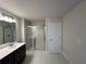 Bathroom featuring a single sink vanity with white countertop, a mirror, and glass shower at 254 Depot Landing Rd # 55, Auburn, GA 30011