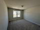 Cozy bedroom with neutral walls, carpeted flooring, and a bright window view at 254 Depot Landing Rd # 55, Auburn, GA 30011