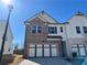 Charming two-story home featuring a brick facade, two-car garage, and modern architectural details at 254 Depot Landing Rd # 55, Auburn, GA 30011