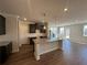 Open kitchen featuring a large island, granite countertops and dark wood cabinets at 254 Depot Landing Rd # 55, Auburn, GA 30011