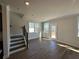 Bright living room with stairs, wood flooring, large windows, and a glass door at 254 Depot Landing Rd # 55, Auburn, GA 30011