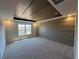 Large main bedroom featuring tray ceilings, wood accent wall, carpet and a window at 254 Depot Landing Rd # 55, Auburn, GA 30011