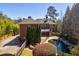Beautiful backyard with a swimming pool, mature trees, and meticulous landscaping at 1364 Manget Way, Dunwoody, GA 30338