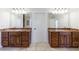 Bathroom featuring double vanities with granite counters and large mirrors with vanity lights at 1364 Manget Way, Dunwoody, GA 30338