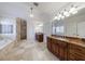 Spacious bathroom featuring double vanities with granite counters, a soaking tub, and separate shower at 1364 Manget Way, Dunwoody, GA 30338