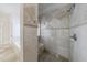 Close-up of a bathroom featuring a tiled shower with built-in bench and a showerhead at 1364 Manget Way, Dunwoody, GA 30338