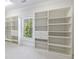 Large walk-in closet featuring custom built-in shelving and storage at 1364 Manget Way, Dunwoody, GA 30338