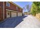 Three-car garage and a brick exterior with a well-manicured driveway at 1364 Manget Way, Dunwoody, GA 30338