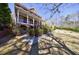Two-story brick home with a covered front porch surrounded by manicured landscaping at 1364 Manget Way, Dunwoody, GA 30338