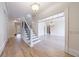 Grand foyer with staircase, hardwood floors, and views into the dining and living spaces at 1364 Manget Way, Dunwoody, GA 30338