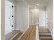 Well-lit hallway with hardwood flooring and white trim, leading to various rooms at 1364 Manget Way, Dunwoody, GA 30338