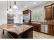 Chef's kitchen boasting a large island, stainless steel appliances, and stone fireplace at 1364 Manget Way, Dunwoody, GA 30338