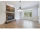 Bright living room featuring stone fireplace and large, bright window at 1364 Manget Way, Dunwoody, GA 30338