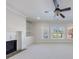 Cozy living room featuring a fireplace, built-in shelving, and large windows for natural light at 1364 Manget Way, Dunwoody, GA 30338