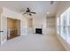 Spacious living room with carpet flooring, a fireplace, built-in bookshelves, and natural light at 1364 Manget Way, Dunwoody, GA 30338