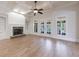 Bright and airy living room with stone fireplace and built-in shelving at 1364 Manget Way, Dunwoody, GA 30338