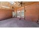 Covered outdoor patio with brick floor, skylights, and ceiling fans for comfortable entertaining at 1364 Manget Way, Dunwoody, GA 30338