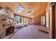 Relaxing covered patio has a stone fireplace, brick floors, and wooded views at 1364 Manget Way, Dunwoody, GA 30338