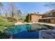 Inviting in-ground pool surrounded by lush landscaping on a sunny day at 1364 Manget Way, Dunwoody, GA 30338