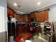 Well-lit kitchen with stainless steel appliances, granite countertops and wood cabinetry at 47 Trailside Cir, Hiram, GA 30141