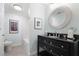 Well-lit bathroom with black vanity, round mirror, and updated fixtures at 549 Trailwood Sw Ln, Marietta, GA 30064