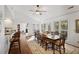 Bright dining room features a large table, hardwood floors and bar seating connecting to the kitchen at 549 Trailwood Sw Ln, Marietta, GA 30064