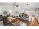 Open-concept dining room flows into kitchen with bar seating, hardwood floors, and neutral decor at 549 Trailwood Sw Ln, Marietta, GA 30064