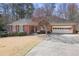 Charming brick ranch-style home with lush landscaping and an attached two-car garage at 549 Trailwood Sw Ln, Marietta, GA 30064