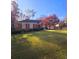 Charming brick home with a well-manicured lawn, mature trees, and an attached two-car garage at 549 Trailwood Sw Ln, Marietta, GA 30064