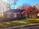 Charming brick home with a well-manicured lawn, mature trees, and an attached two-car garage at 549 Trailwood Sw Ln, Marietta, GA 30064