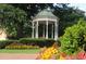 Charming gazebo nestled in a landscaped park setting, surrounded by colorful flowers and lush greenery at 549 Trailwood Sw Ln, Marietta, GA 30064