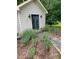 Outbuilding with black sconce lighting flanking blue-gray double doors at 549 Trailwood Sw Ln, Marietta, GA 30064