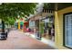Vibrant storefronts with awnings along a brick sidewalk, showcasing a bustling commercial area at 549 Trailwood Sw Ln, Marietta, GA 30064