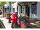 Charming street view with a vibrant red scooter and potted plants by Square Threads boutique store at 549 Trailwood Sw Ln, Marietta, GA 30064
