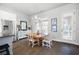 Dining area with stainless steel refrigerator, hardwood floors, and natural light at 217 Napa Dr, Woodstock, GA 30188