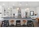 Kitchen island with bar seating, stainless appliances, and pendant lighting fixtures at 217 Napa Dr, Woodstock, GA 30188