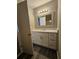 Bright bathroom featuring a white vanity with marble countertops, complemented by modern lighting and stylish mirror at 2179 Summertown Dr, Norcross, GA 30071