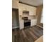 Modern kitchen featuring stainless steel range and hood, white cabinets, and updated countertops at 2179 Summertown Dr, Norcross, GA 30071