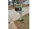 Close-up of a black mailbox with white numbers 2179, mounted on a green wooden post at 2179 Summertown Dr, Norcross, GA 30071